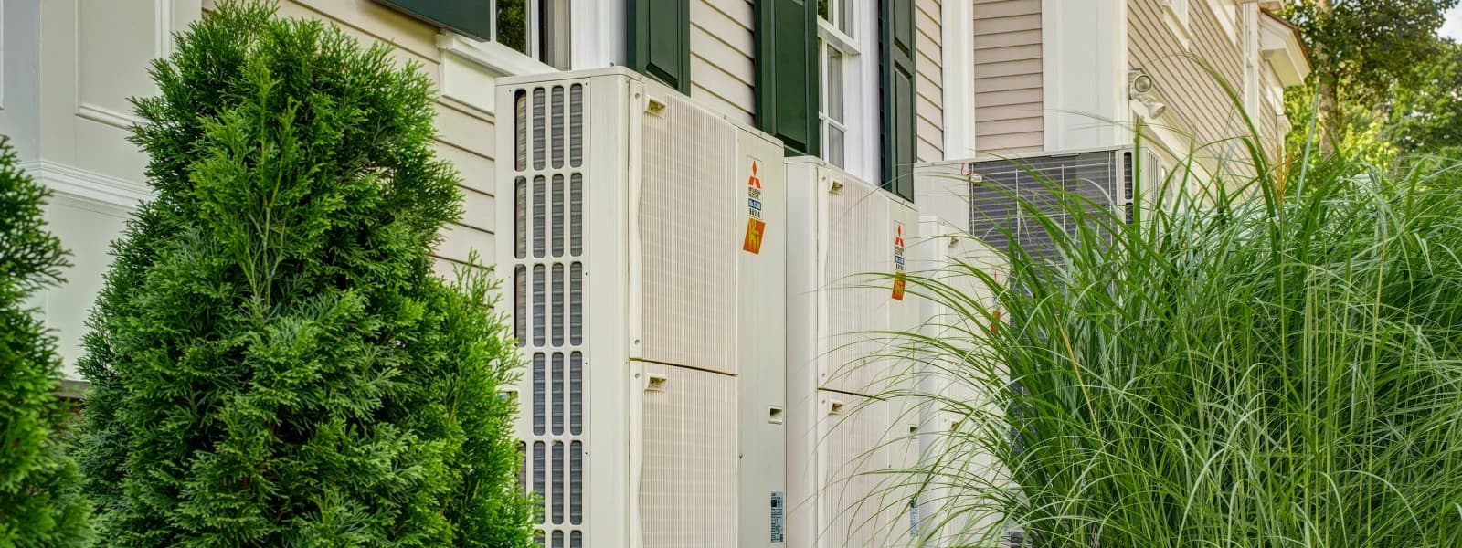 Multiple Mitsubishi Electric outdoor units alongside a building