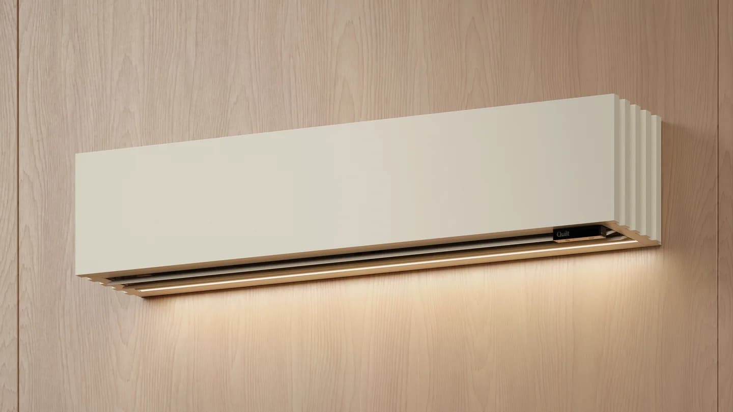 Quilt indoor heat pump with wood front cover and downward light, on a wood wall